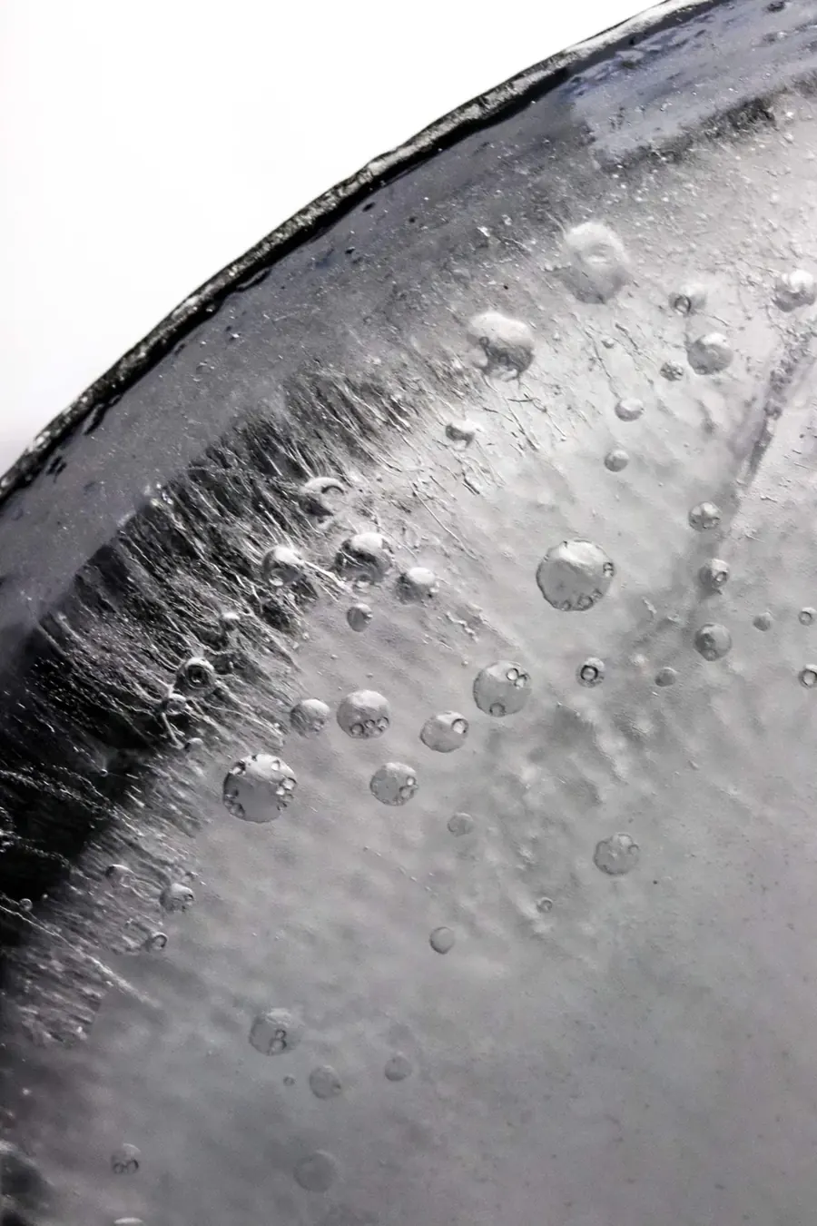 A black and white photography of Ice showing its textures.