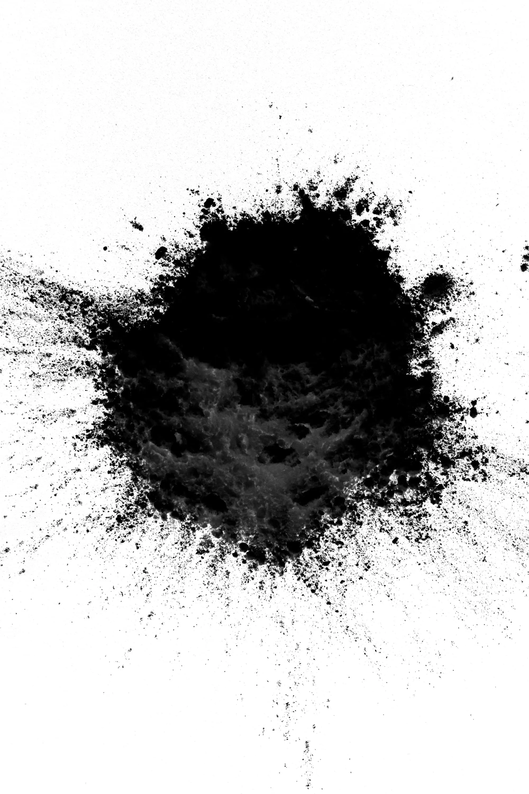 Photography of an experiment with flour. Black flour on white background.