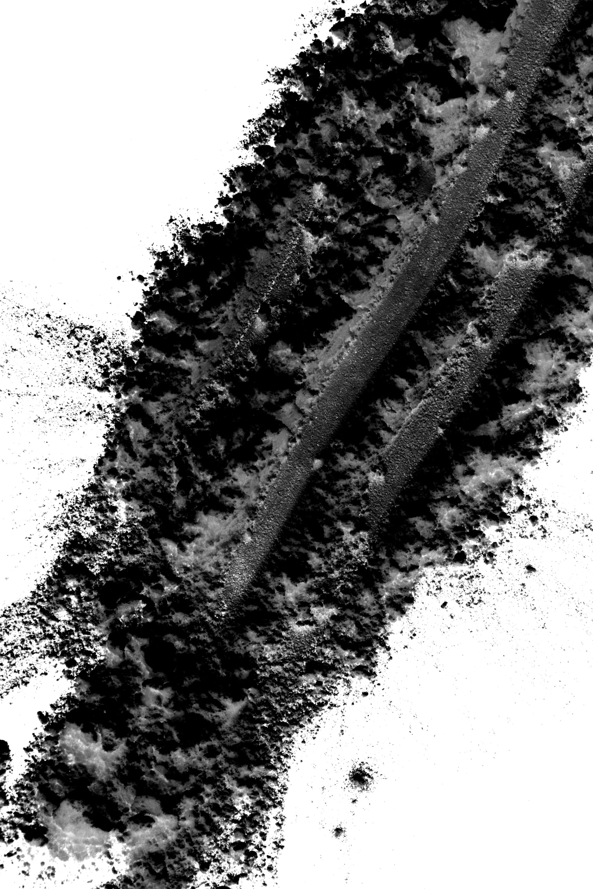 Photography of an experiment with flour. Black flour on white background.