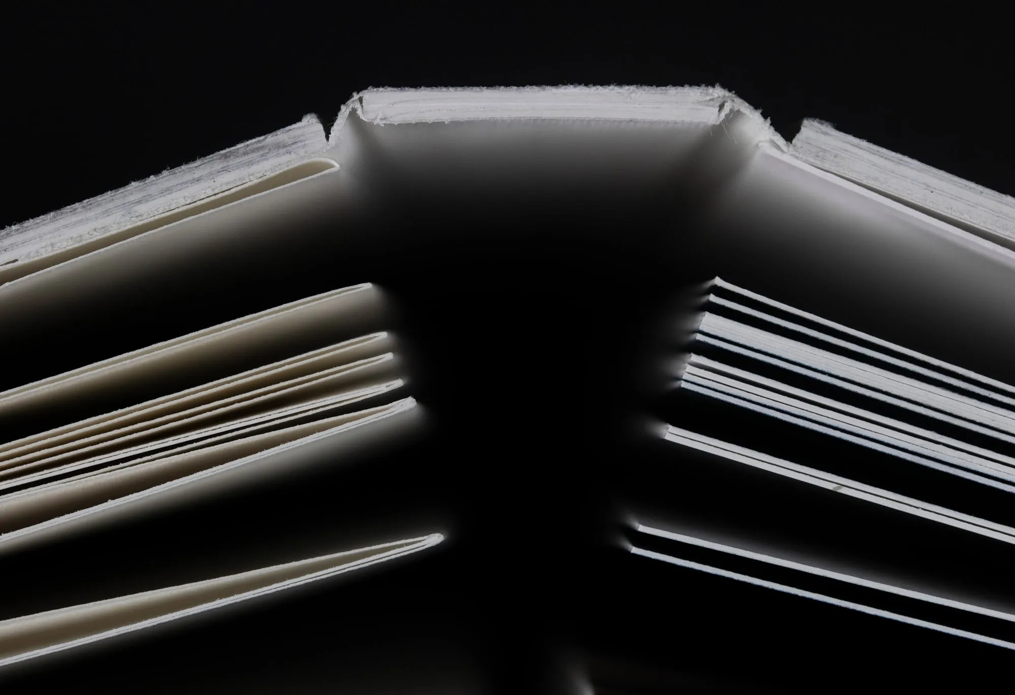 Top view of the book about the production of technical snow, showing the binding and the two parts: one with thin pages and one with thick pages.
